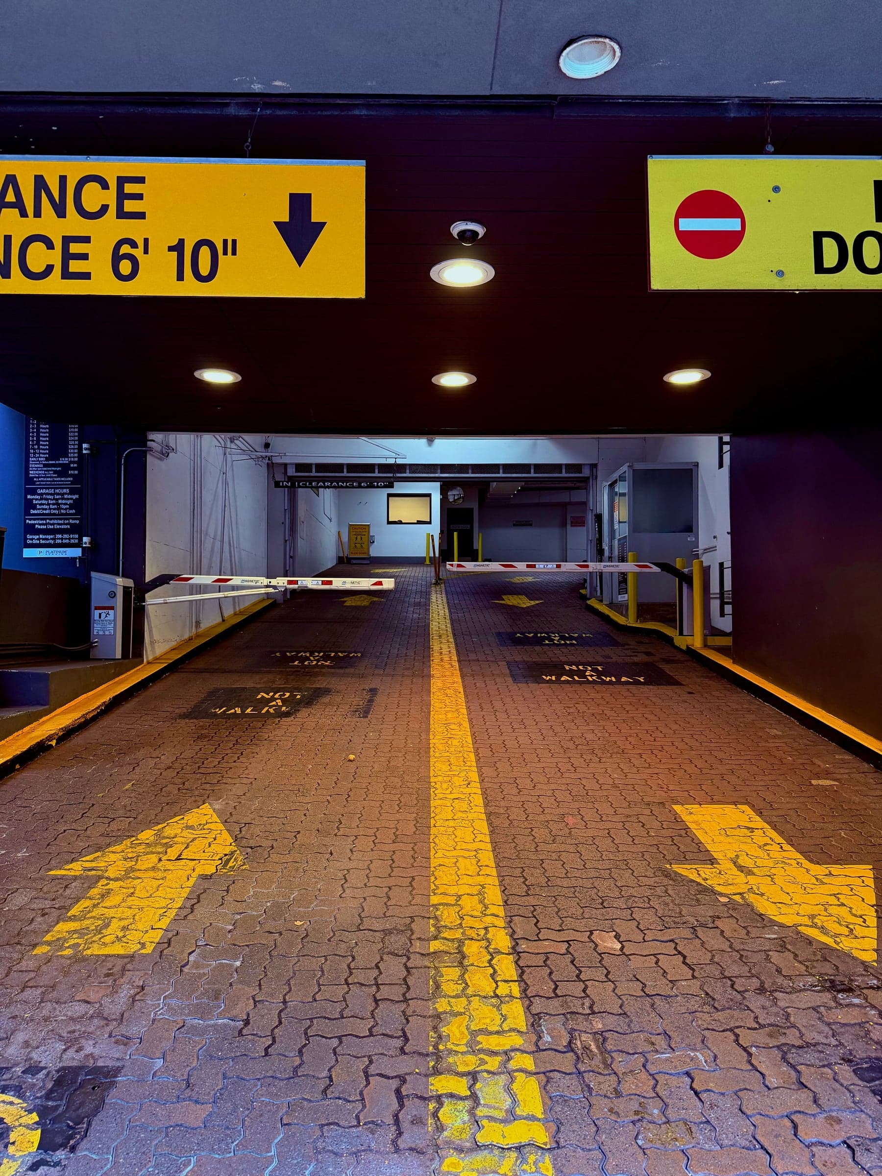 A parking garage entrance with booms