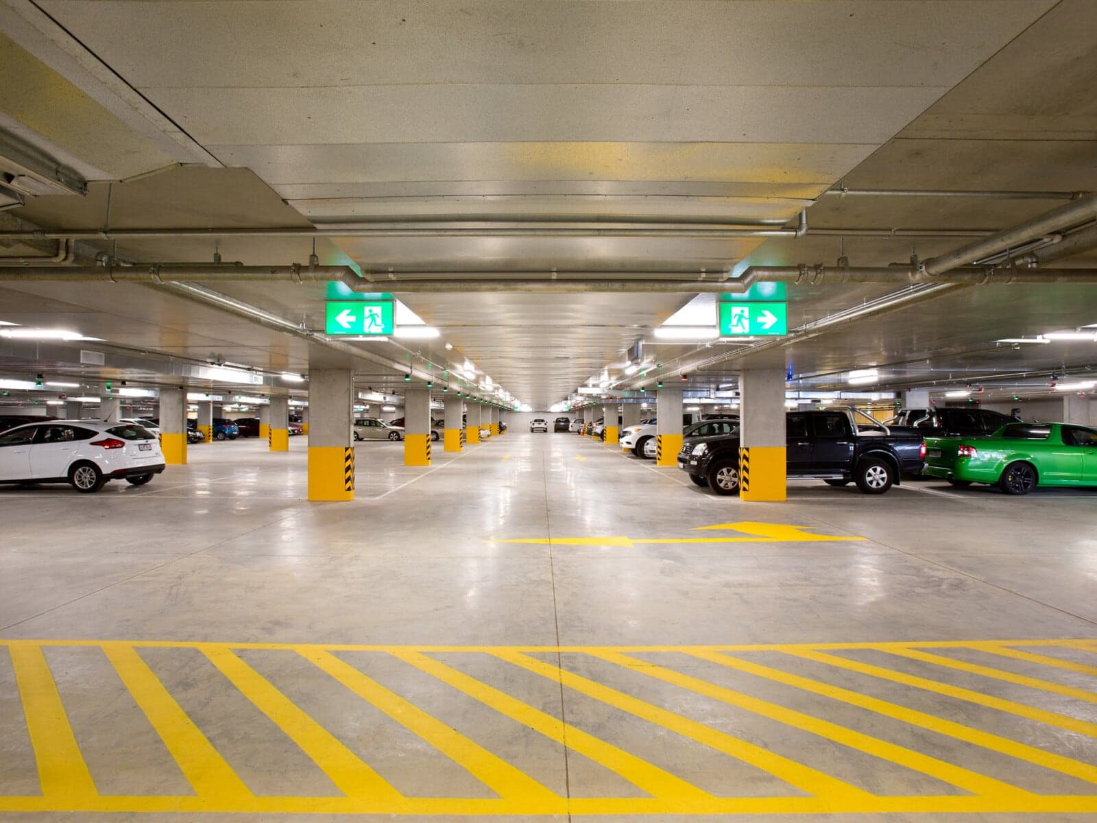 A lit parking deck, lanes marked in yellow