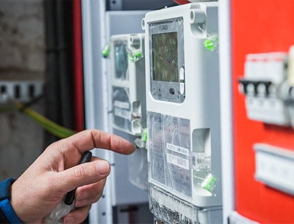 A technician at a prepaid meter board