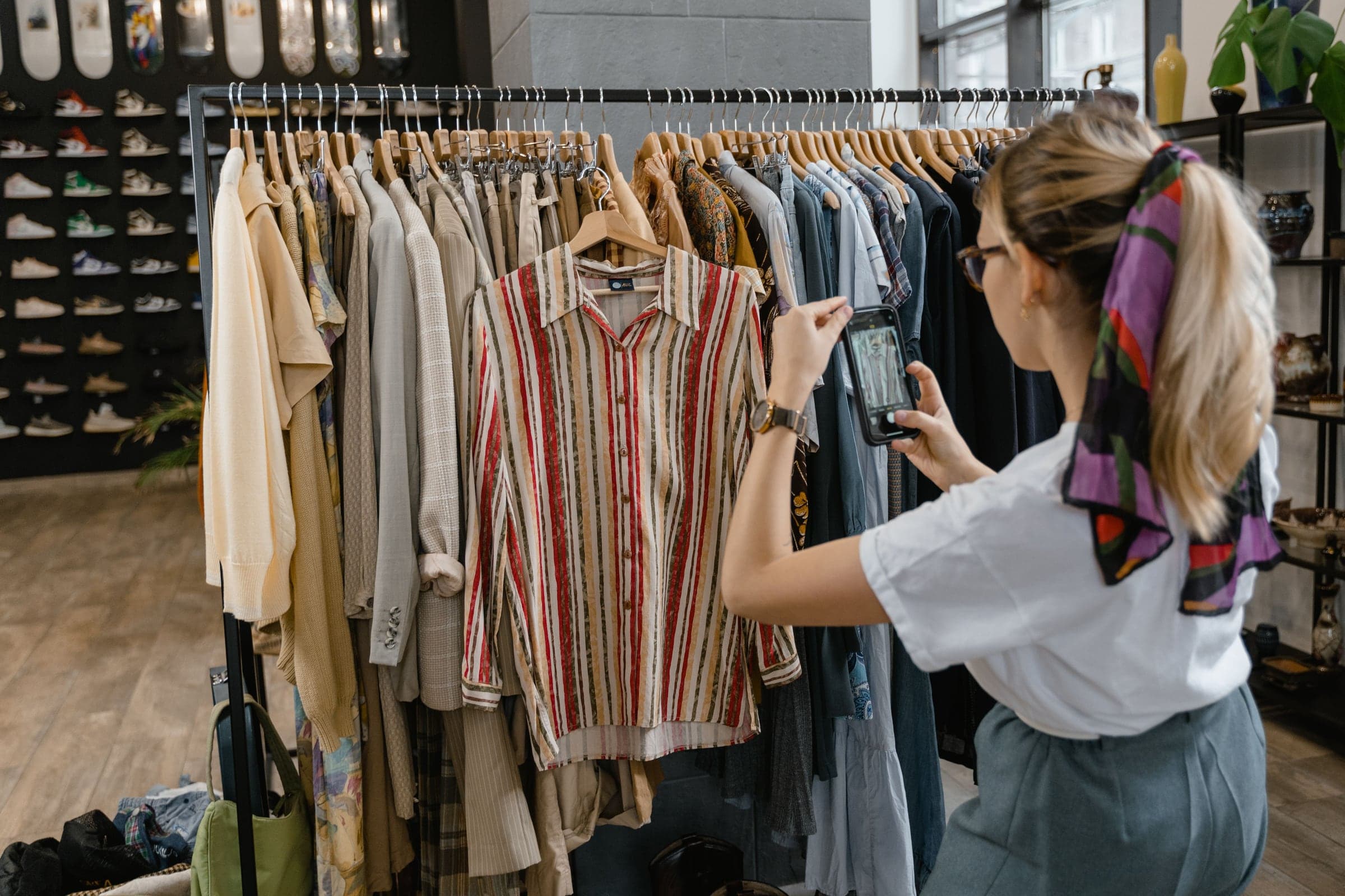 Scanning a garment's tag with a phone in a boutique