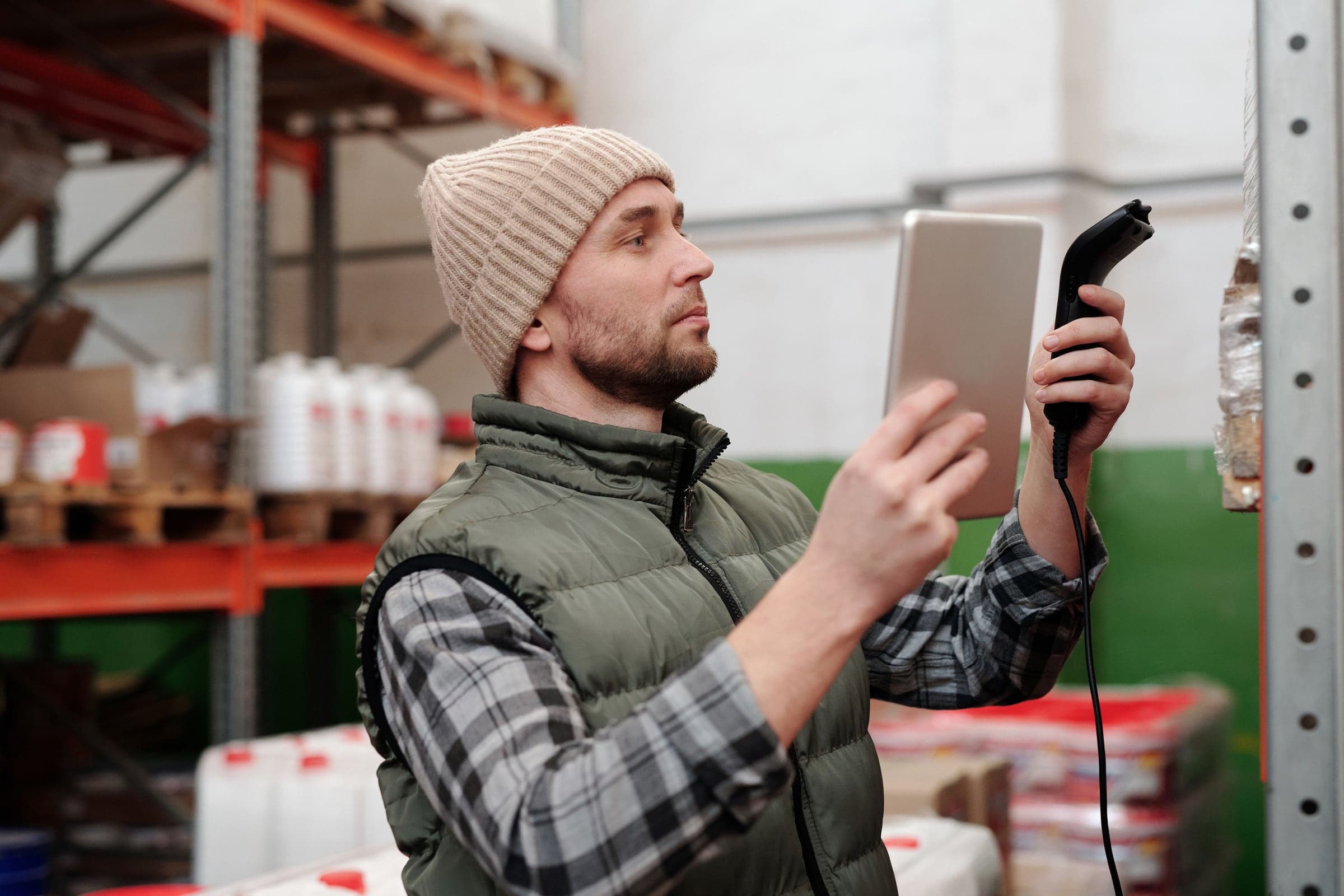 A warehouse worker with a tablet and scanner